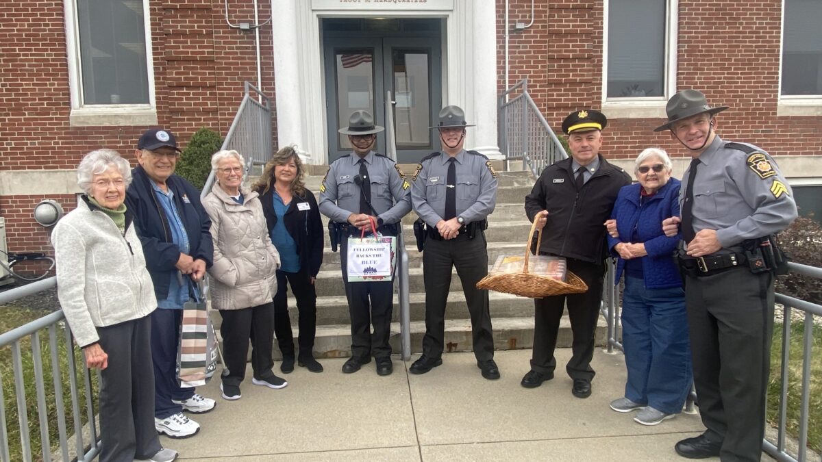 Group of residents giving treats to area state police