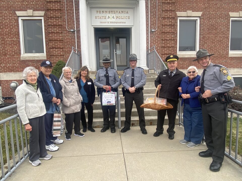 Group of residents giving treats to area state police